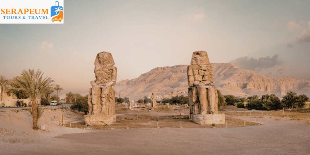 Two giant statues of Colossi of Memnon in Luxor Egypt